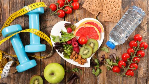 table filled with health fruits and nuts and weights and measuring tape