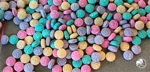 rainbow fentanyl spilled on a counter