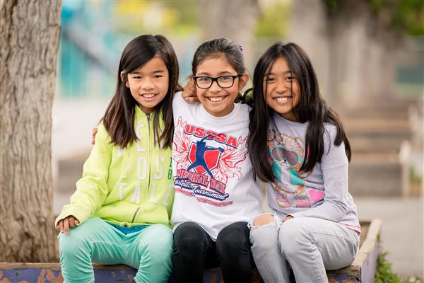 three students smiling three students smiling