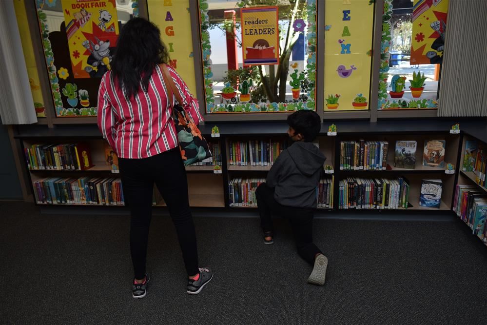 mother and son in library